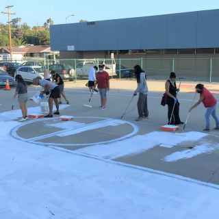Youth RLA preparing the court for mural art