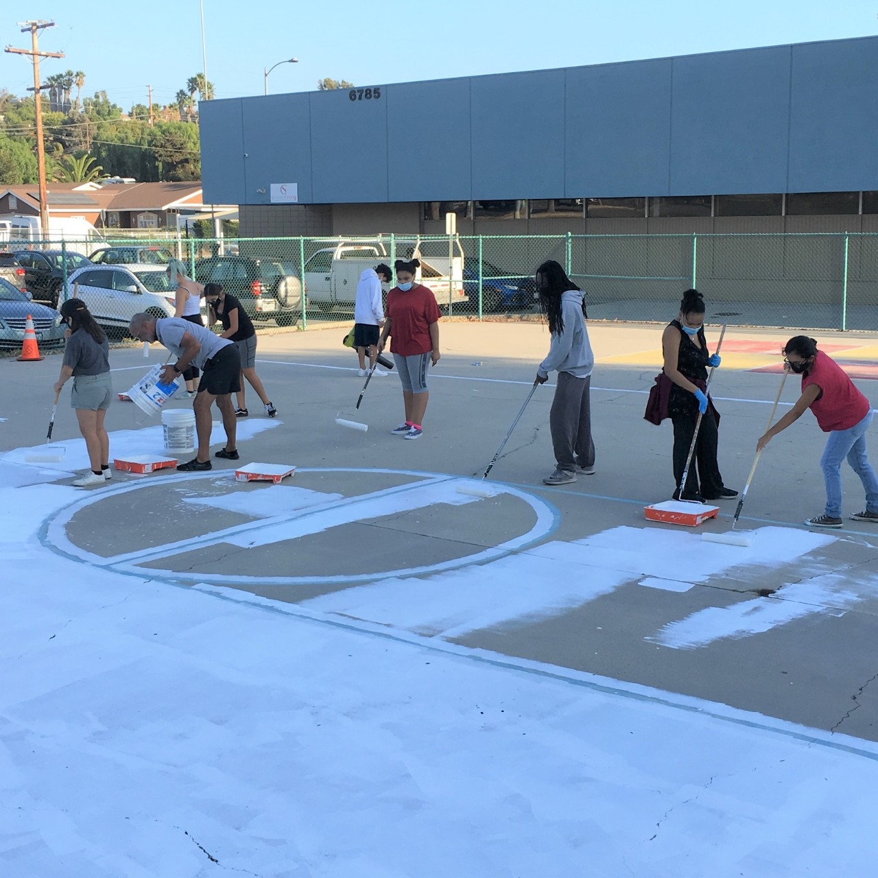 Youth RLA preparing the court for mural art