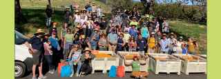 people smiling after fruit collection