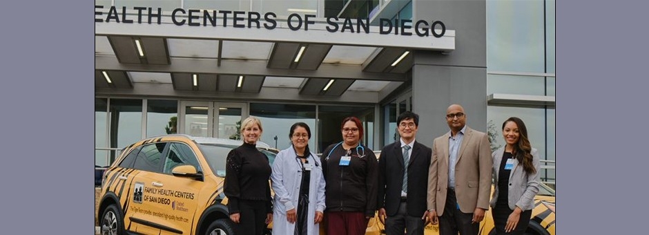 United Healthcare workers in front of building and car