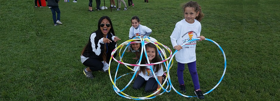 Intern with kids playing with hoola-hoops