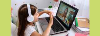 little girl having a virtual meeting with reading mentor 