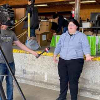Computer recipient Aurora being interviewed by a local news station about the computer giveaway event