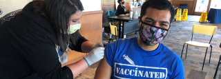 Man receives flu vaccine at a clinic