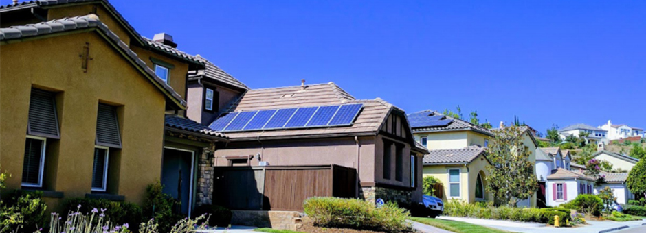 Houses have solar panels on roofs to help reduce emissions