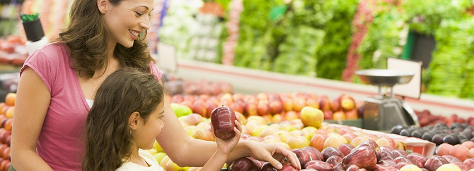 Mother and daughter shop for vegetables